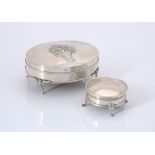 An Edwardian silver oval dressing table box by William Comyns