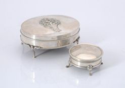 An Edwardian silver oval dressing table box by William Comyns