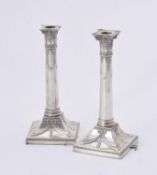 A pair of Edwardian silver candlesticks by Thomas Bradbury & Sons