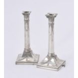 A pair of Edwardian silver candlesticks by Thomas Bradbury & Sons