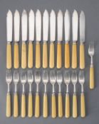 Y A set of eleven silver fish knives and twelve forks by Atkin Bros.