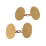 A pair of gold coloured cufflinks