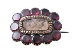 A 19th century garnet and hairwork brooch