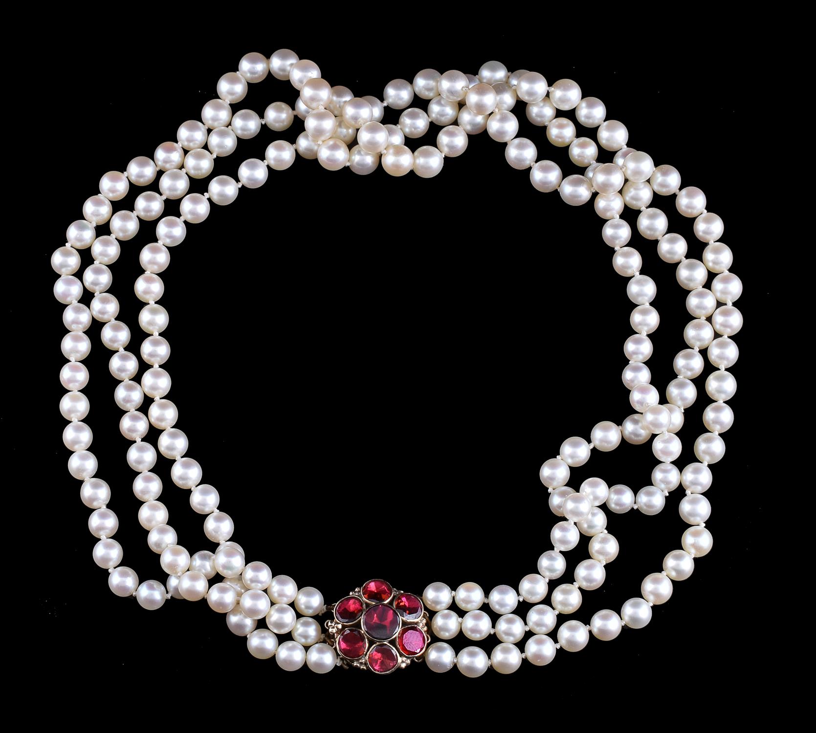 A three row cultured pearl and garnet necklace