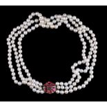 A three row cultured pearl and garnet necklace