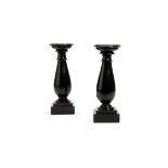 A pair of Victorian slate or Derbyshire Black Ashford marble turned candle holders