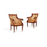 A pair of exotic hardwood and canework library armchairs in George IV style