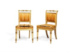 A pair of late George III white painted and parcel giltwood side chairs