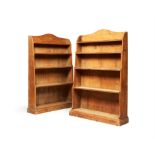 A pair of Regency pine 'waterfall' open bookcases