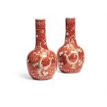 A pair of Chinese re-ground 'Phoenix' bottle vases
