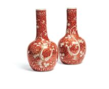 A pair of Chinese re-ground 'Phoenix' bottle vases