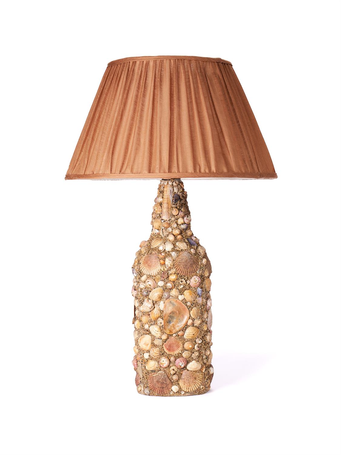 A shell encrusted bottle fitted as a table lamp