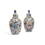 A large pair of Delft vases and covers