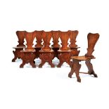 A set of eight George II mahogany hall chairs