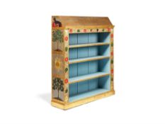 A painted and parcel gilt decorated open bookcase in Arts and Crafts style