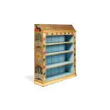 A painted and parcel gilt decorated open bookcase in Arts and Crafts style