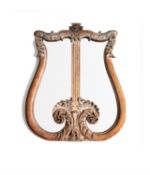 A limed oak wall mirror in the form of a lyre