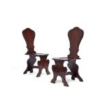 A pair of George II mahogany hall chairs