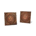A pair of Northern European relief carved and parcel painted softwood wall plaques