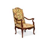 A French walnut and tapestry upholstered open armchair in Louis XV style