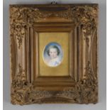 Y A small oval miniature portrait on ivory of a child