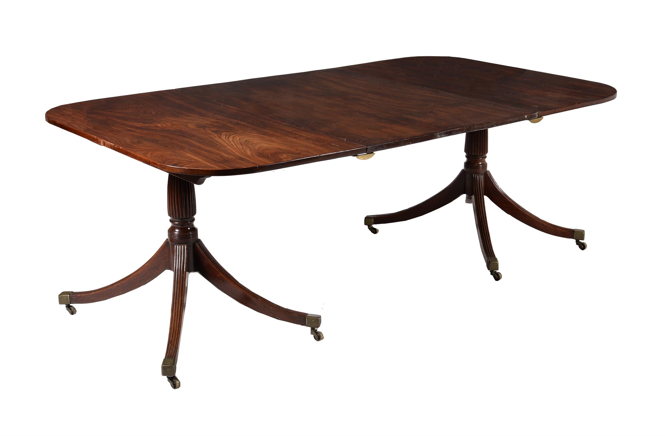 A mahogany twin pillar extending dining table