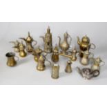 A collection of Middle Eastern brass ewers and coffee pots