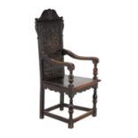 A carved oak wainscot chair in 17th century style