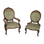 A Victorian walnut and upholstered open armchair