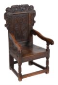 An oak panel back armchair, 17th century and later