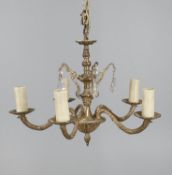 A gilt metal and cut glass five light chandelier