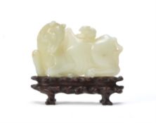 An unusual Chinese pale celadon jade 'horse and squirrel' belt buckle