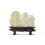 An unusual Chinese pale celadon jade 'horse and squirrel' belt buckle