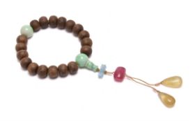 A Chinese aloeswood and jadeite rosary bracelet