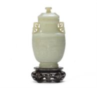 A Chinese pale celadon jade archaistic vase and cover
