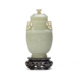 A Chinese pale celadon jade archaistic vase and cover