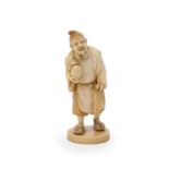 Y A Japanese Ivory Okimono carved as an elderly man wearing a soft hat and standing on an oval base