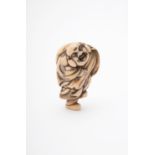 Y A Japanese Ivory Netsuke carved as Hotei