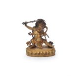 A Sino-Tibetan gilt-bronze figure of Dharmapala