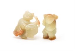 Two Chinese pale celadon and russet jade carvings of boys