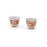 A pair of iron-red 'Dragon' wine cups