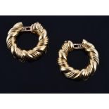 A pair of gold ear hoops by Van Cleef & Arpels