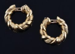 A pair of gold ear hoops by Van Cleef & Arpels