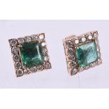 A pair of emerald and diamond cluster earrings