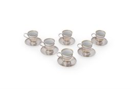 Cartier, a set of six plain silver and porcelain demitasse coffee cups and saucers