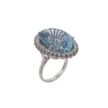 A 1980s 18 carat gold diamond and aquamarine cluster ring by Garrard & Co.