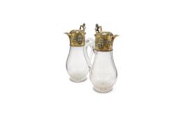 A pair of Victorian silver gilt and clear glass claret jugs by Richard Sibley II