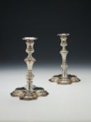 A pair of George II cast silver shaped square candlesticks by John Jacob
