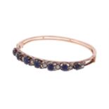 A late Victorian and later sapphire and diamond hinged bangle