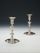 A pair of late George II cast silver shaped square candlesticks by John Cafe